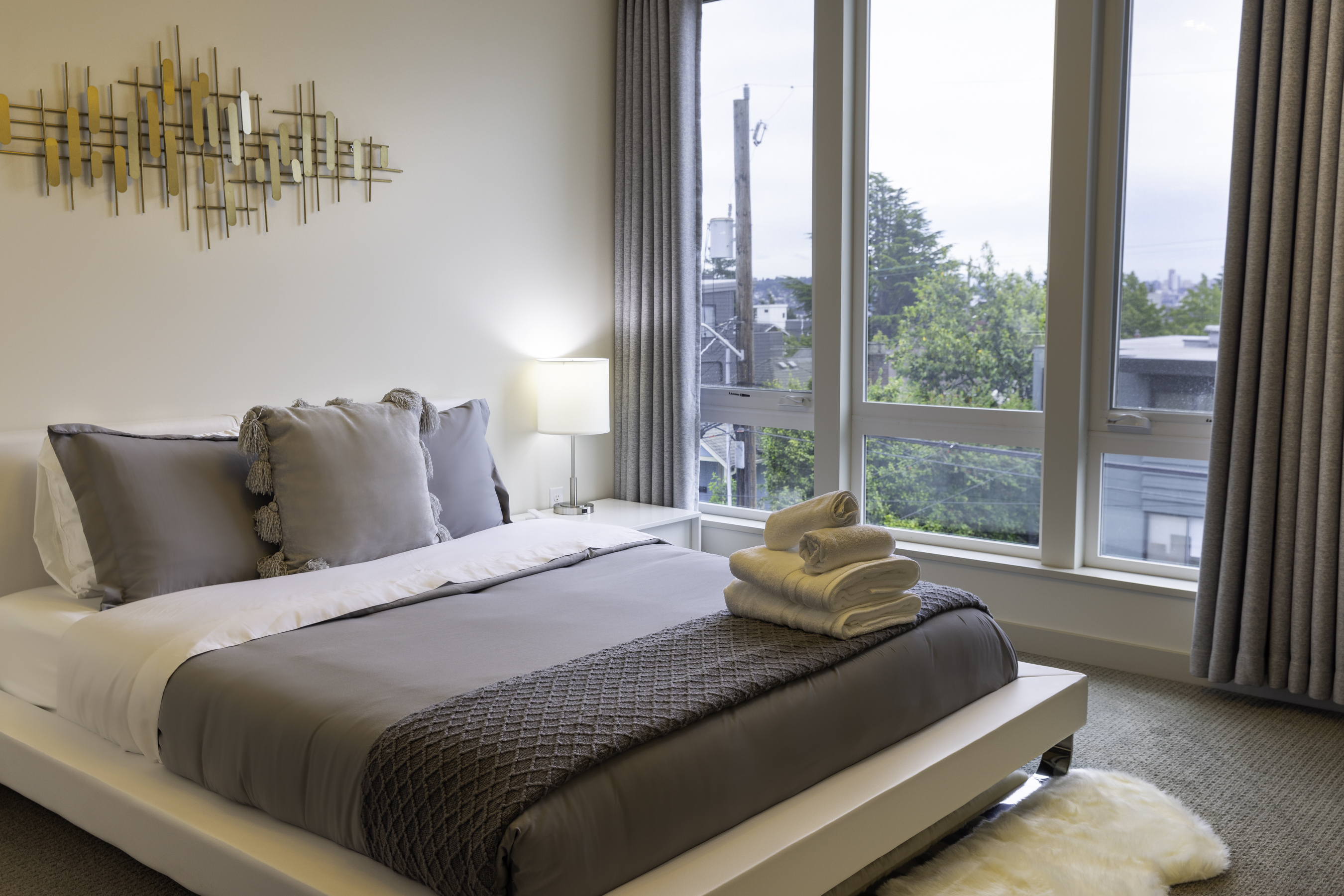 Primary bedroom with queen bed and motorized shades